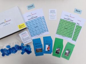 Bingo cards and blue and green cards with pictures of objects on them.