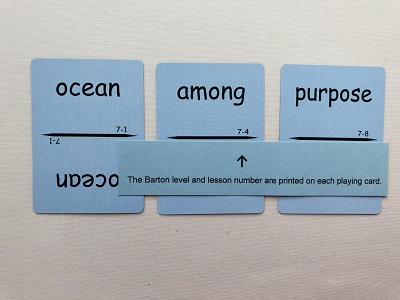3 sight word cards from level 7 sight word slap it game with blue paper pointing to barton level and lesson on each card